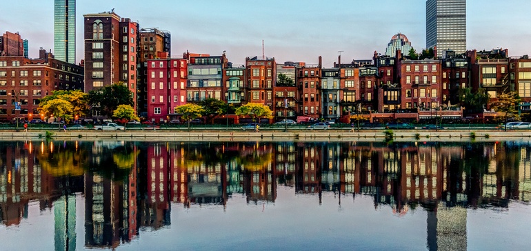 Reflection Of Smart City Boston Skyline In River Offering Affordable Housing Funding