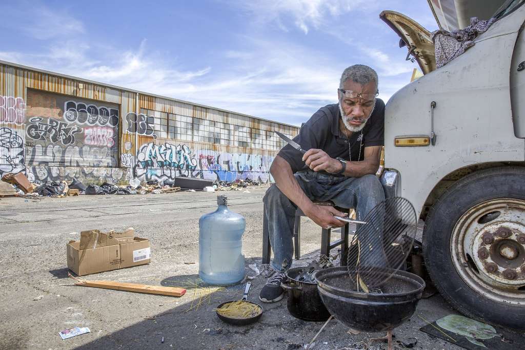 Homeless Veteran Man Barbecuing On Street Holding BBQ Grill In San Mateo County