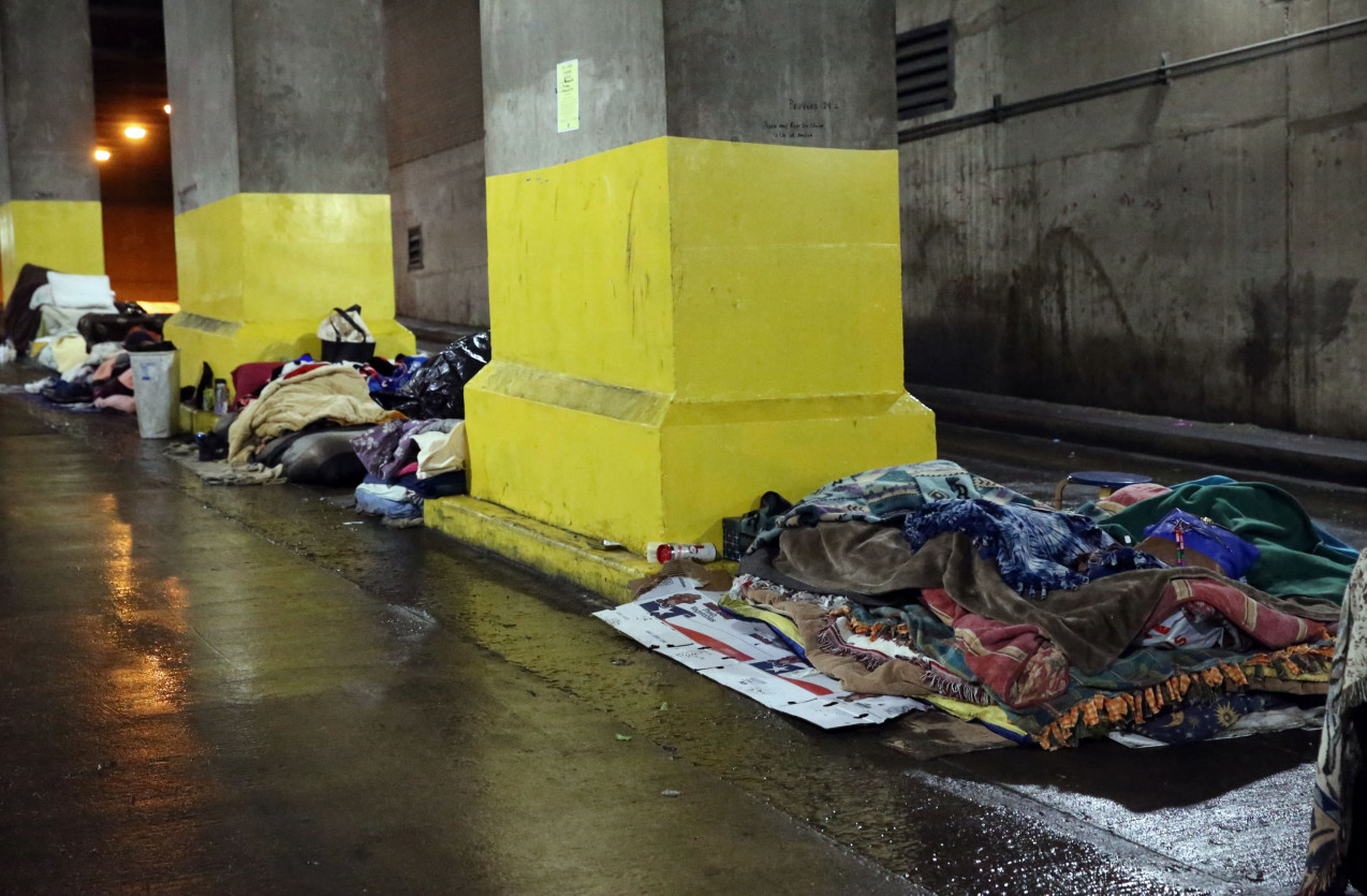 Homeless Blankets On The Wet Ground Next To Yellow Pillars In Cook County Chicago