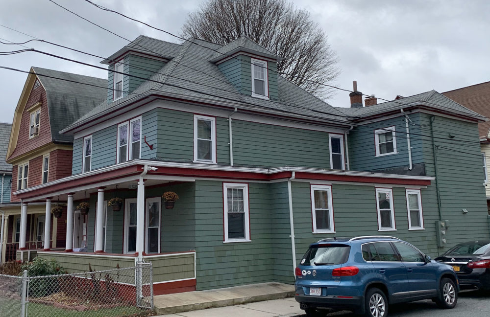 Three Story Green Teal house With Red Trim In Boston For Youth Without Homes