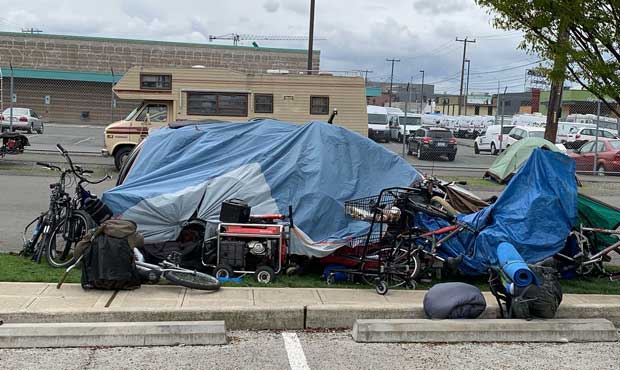 Large Tarp Covering Bikes And Homeless Carts On Side Of The Road In Seattle King County